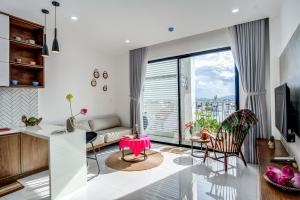 a living room with a view of a city at MTR Apartment & Hotel in Da Nang