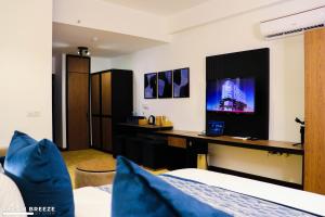 a hotel room with a bed and a desk at Ocean Breeze by DOXA in Negombo