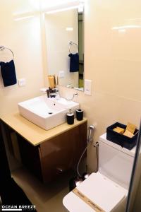 a bathroom with a sink and a toilet at Ocean Breeze by DOXA in Negombo