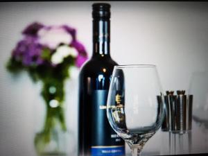 巴拉的住宿－Drainllwyn，葡萄酒杯旁的一瓶葡萄酒