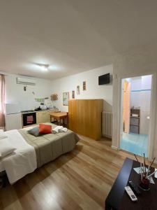 a bedroom with a large bed and a kitchen at The Artist's Home Catania Centro in Catania