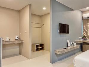 a bathroom with a toilet and a sink at The Coconut Hotel in Lampang