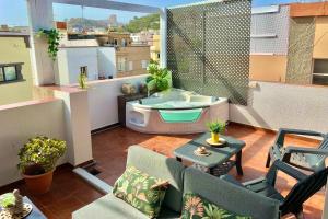 a balcony with a bath tub on a roof at Las Brisas Penthouse by SunHousesCanarias in Las Palmas de Gran Canaria