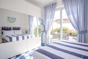 a hotel room with two beds and a balcony at Villa Sterlizia in Capri