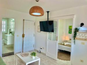 a living room with a television and a room at Las Brisas Penthouse by SunHousesCanarias in Las Palmas de Gran Canaria