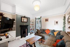 a living room with a couch and a fireplace at Wellington - Matlock in Matlock