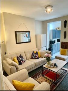 a living room with a couch and a table at Lovely House by the park. in Walkley