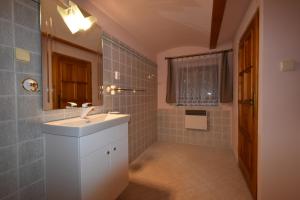 a bathroom with a sink and a mirror at Chalupa Alexandra in Kacanovy +21 photos