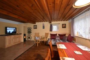a living room with a couch and a table at Chalupa Alexandra in Kacanovy