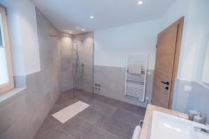 a bathroom with a shower and a sink at Apart Eder in Schwendau