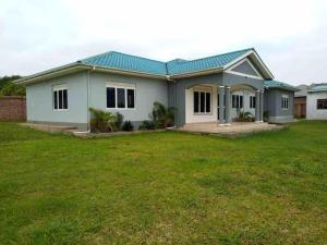 a house with a green lawn in front of it at KareBer Deluxe - Gulu - Uganda in Gulu
