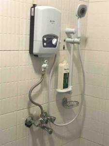 a soap dispenser on a wall in a bathroom at KareBer Deluxe - Gulu - Uganda in Gulu