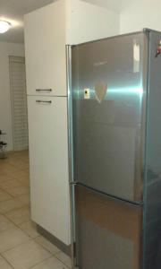 a stainless steel refrigerator with a heart on the door at Le Coton Verde , 2 nuits minimum in Sainte-Rose