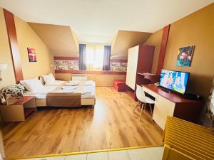 a large room with a bed and a desk at Grami Hotel in Bansko +66 photos
