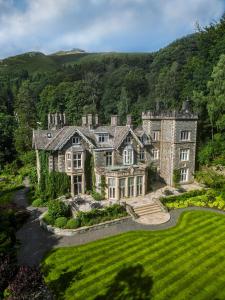an estate in the hills with a green lawn at Forest Side Hotel in Grasmere