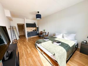 a bedroom with a bed and a living room at Modernes Apartment Nähe Chemnitz in Neukirchen