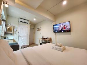 a hospital room with a bed and a flat screen tv at Canal View Lo-ha guest house, Contactless Check-in in Bangkok