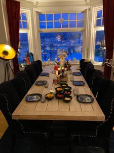 a long wooden table with food on top of it at BraMy Apartments The LUX View in Tromsø