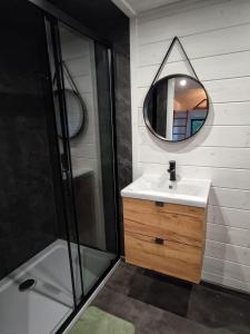 a bathroom with a sink and a mirror at Domek w górach balia Tiny House Polana Widokówka in Lipnica Wielka