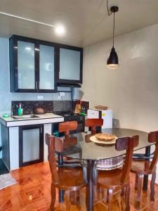 a kitchen with a table with a pizza on it at Z and J Transient House in Butuan