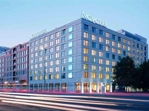 a large building with a sign on top of it at Novotel Berlin Mitte in Berlin