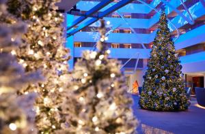 a group of christmas trees in a room at Conrad New York Downtown in New York