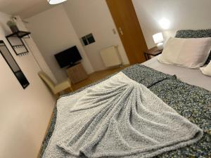 a bedroom with a bed with a blanket on it at Melody's Apartment in Nordenham
