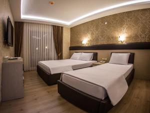 Postel nebo postele na pokoji v ubytování Payidar Hotel