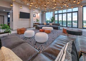 a living room with a couch and a table at The Elm, a Ramada by Wyndham in Little Elm