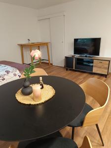 a room with a table with a candle and a bed at Studio apartman Peti in Varaždin