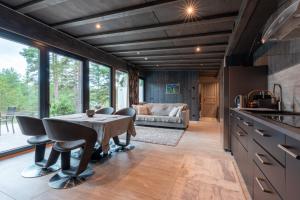 a kitchen and living room with a table and chairs at Dream Corner Nordic in Laulasmaa