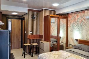 a bedroom with a bed and a desk at CB408 Apartament Beach condo 777 in Phuket