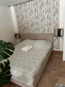 a small bed in a room with a wall at Appartement coeur de ville -Clim, ascenseur, wifi- in Avignon