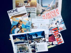 a collage of magazines and newspapers on a table at Blue Hill House, King-of-Hill Villa with amazing scenery, sunset & sea view in San Jose