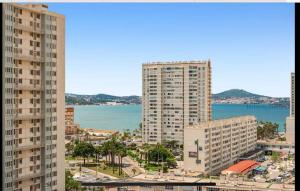 a view of a city with tall buildings and the ocean at Toulon entre Mer et Terre in Toulon