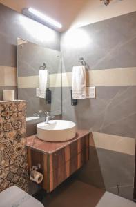 a bathroom with a sink and a mirror at The Lake Ambience Resort in Bhīm Tāl