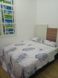 2 camas num quarto com uma janela em NUR MUHAMMAD HOMESTAY em Kubang Kerian