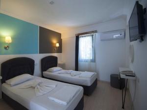 Postel nebo postele na pokoji v ubytování Smart City Bodrum Hotel