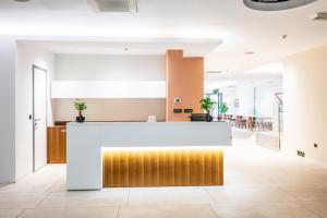 an office lobby with a white and gold counter top at Superb Petrova Street Rooms in Zagreb