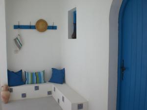 a room with a couch and a blue door at Dar Chick Yahia Ile De Djerba in Mezrane