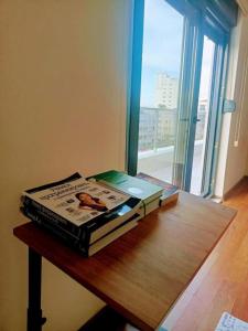 two books sitting on top of a table with a window at Old Town Grand Apart Hotel in Antalya