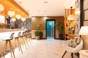 a bar in a restaurant with stools at Hotel Don Diego in Suances