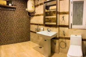 a bathroom with a sink and a toilet at Uptown Boutique Home - 2BHK with drive-in in Shimla