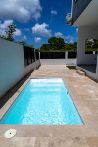 a swimming pool on the side of a house at Spacious 3BR Home with Own Private Cozy Pool in Koolbaai