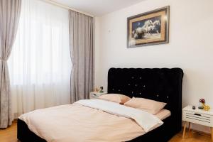 1 cama con cabecero negro en un dormitorio en AZUR CYAN HOUSE, en Bucarest
