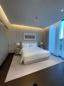 a bedroom with a white bed and a large window at Best opportunity in emaar in Istanbul
