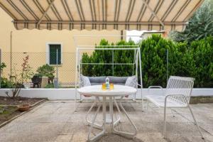 a patio with a white table and two chairs at Jolly Private Room With Bathroom in Marghera