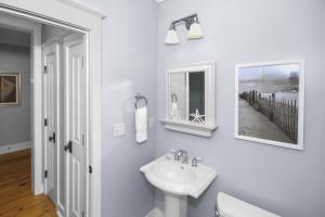 a white bathroom with a sink and a mirror at Beautiful 2 BR WaterColor 6 WaterColor Blvd #201 Steps to Beach Club condo in Santa Rosa Beach