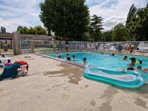 a group of people swimming in a swimming pool at MOBIL HOME in Ivry-la-Bataille