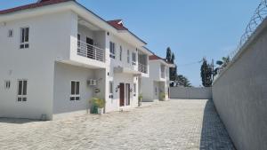 a row of white houses on a brick street at Firenze Apartments Lekki in Lagos